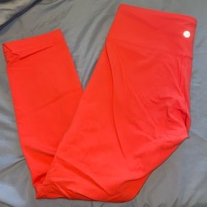 Coral colored Lululemon leggings.